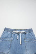 Wide-leg blue jeans with elastic drawstring waist and patch pockets