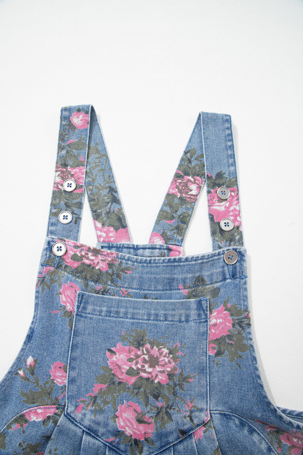 Blue floral denim short overalls with adjustable straps and bib pocket