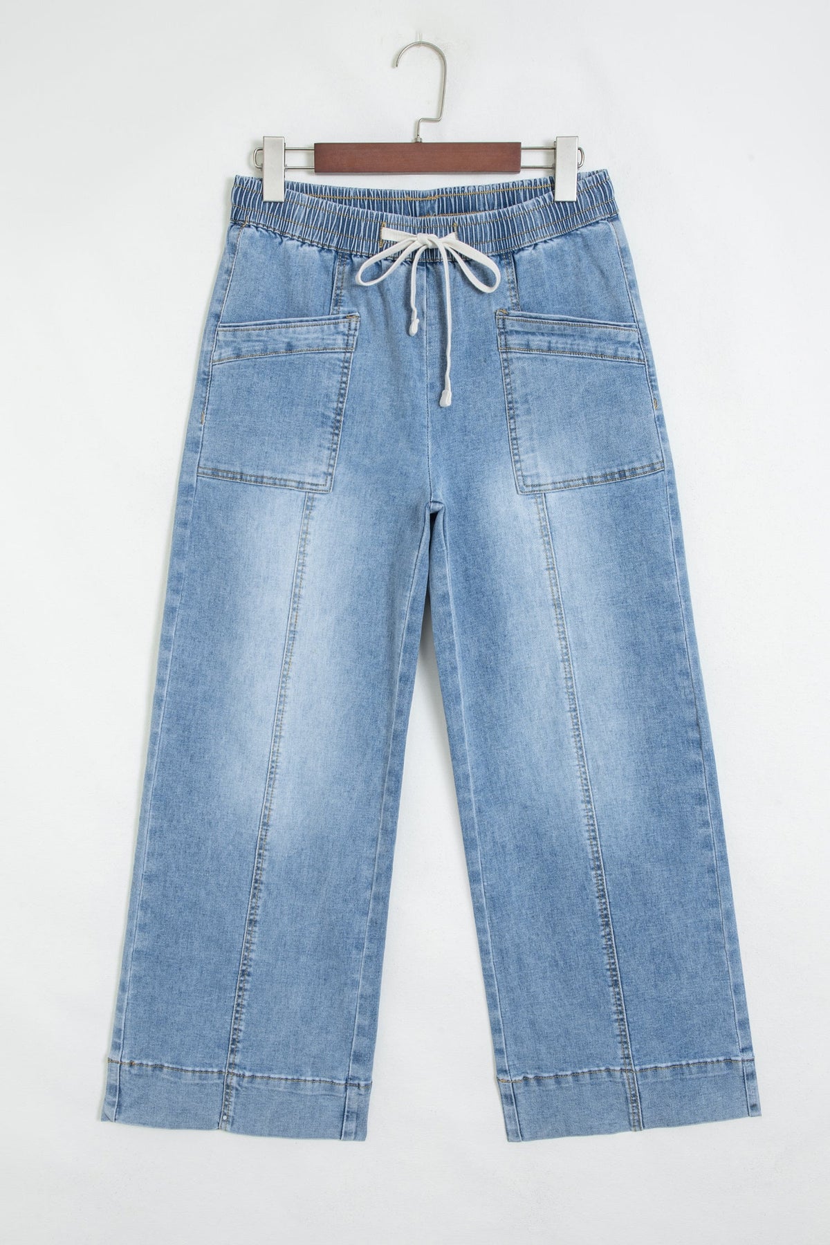 Wide-leg blue jeans with elastic drawstring waist and patch pockets