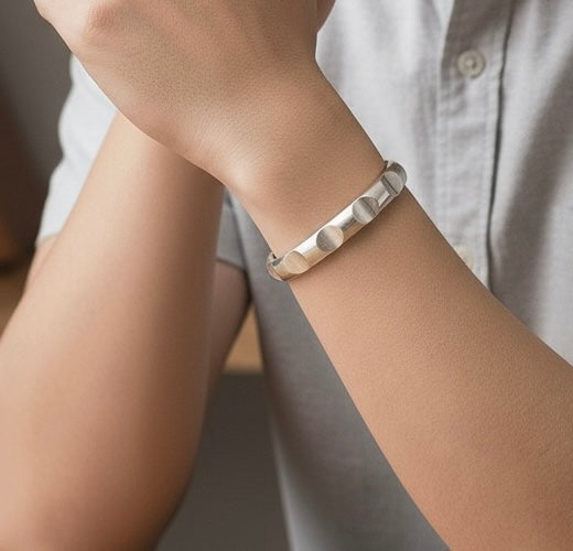 Silver adjustable bangle cuff with circular indent design