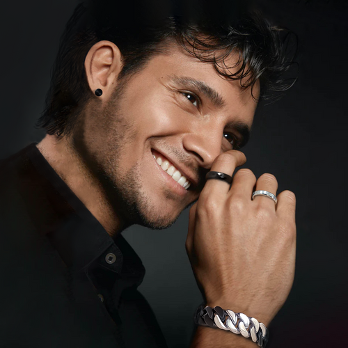 Model wearing a black and stainless flat Cuban link bracelet