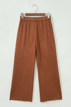 High-waist trousers with scalloped edges and zip pockets