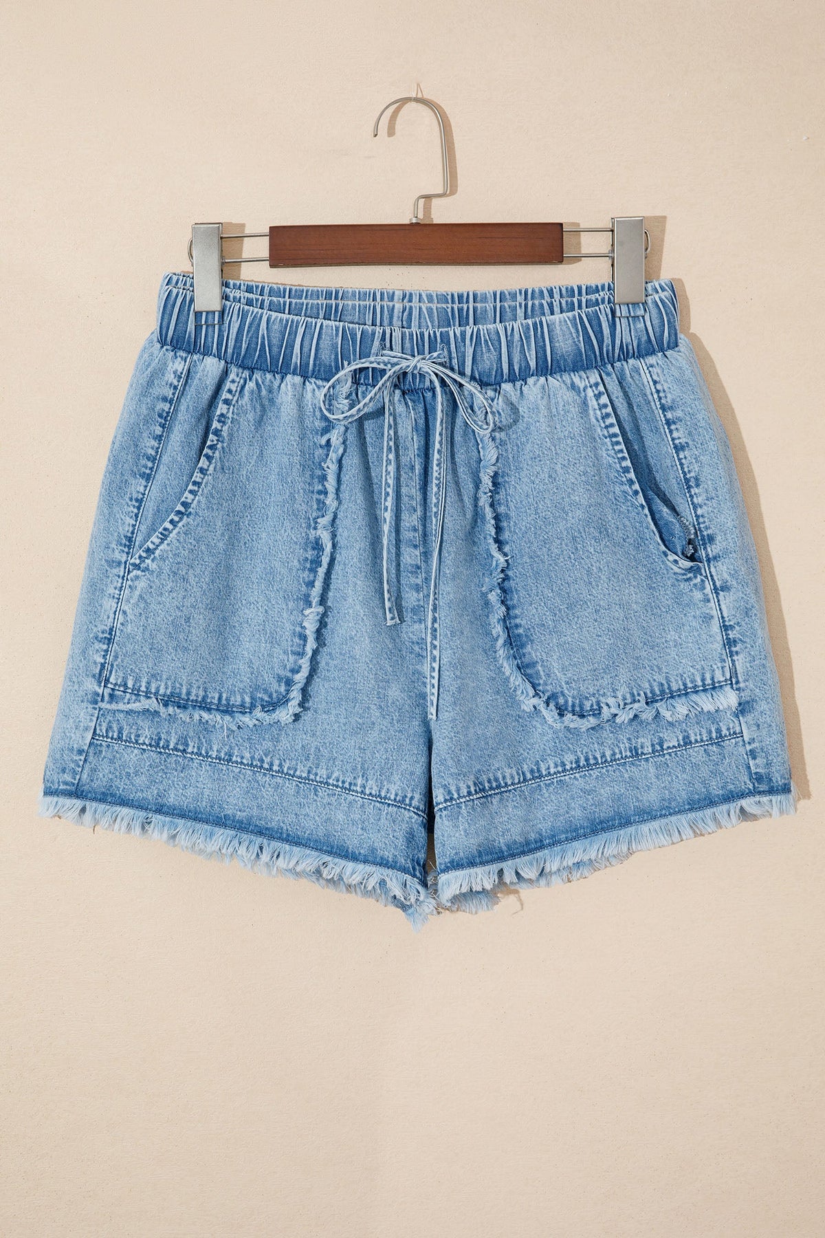 Acid wash denim shorts with frayed hem and drawstring waist