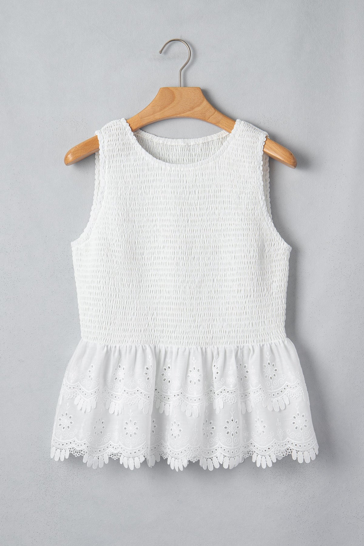 Smocked sleeveless peplum top with eyelet lace